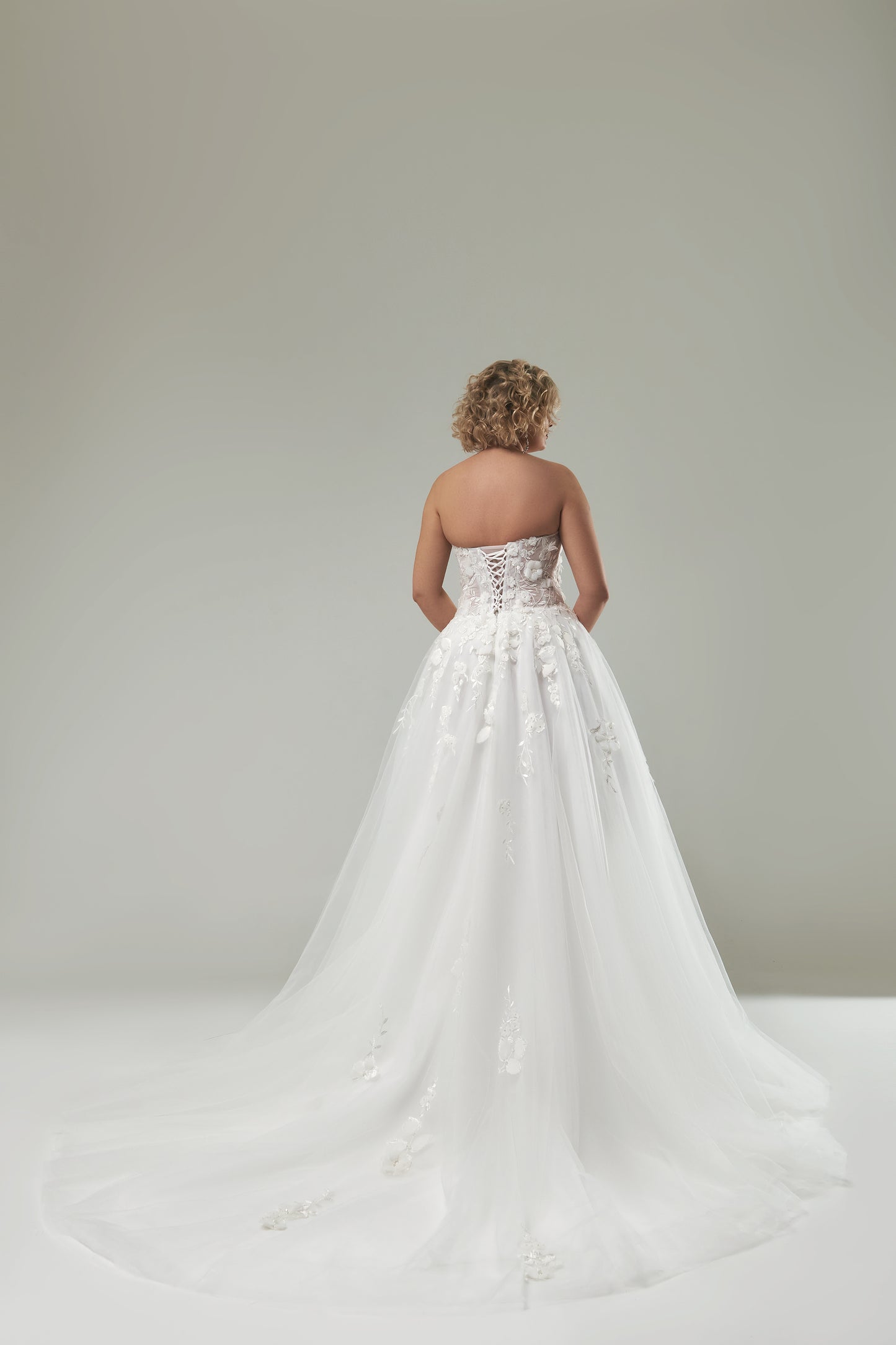 Bridal gown with handmade 3D floral lace appliqués for full-figured women