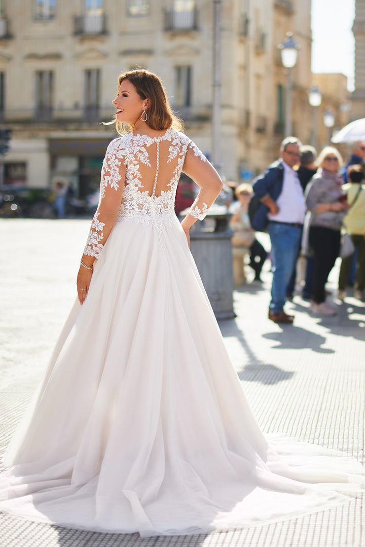 Romantic bridal gown for plus-size women with soft lace and sheer long sleeves