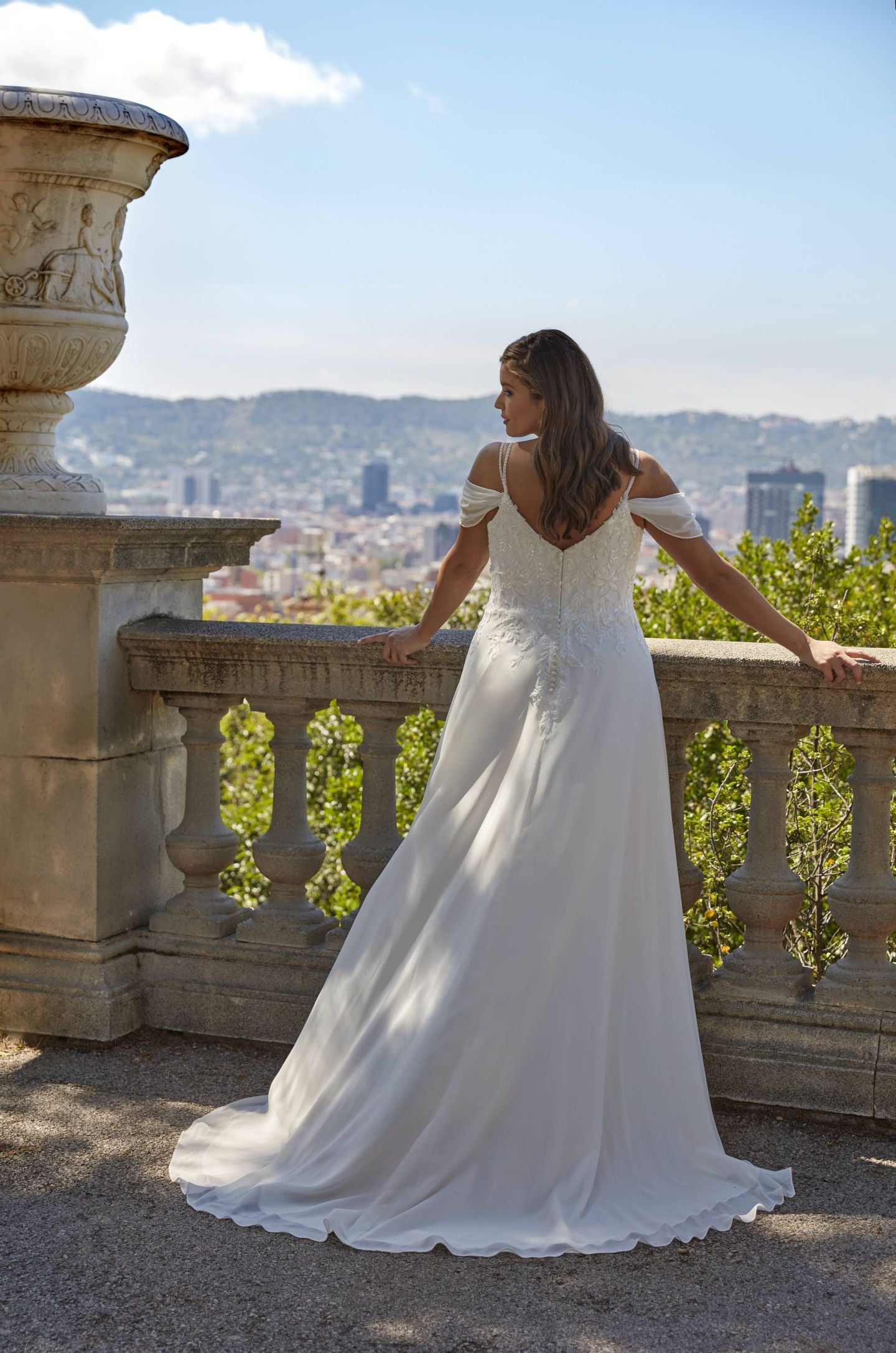Side view of CANANTA Bridal plus size chiffon A-line wedding gown