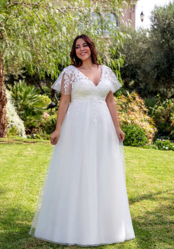 Curvy bridal dress featuring floral applique and delicate tulle sleeves for plus size brides