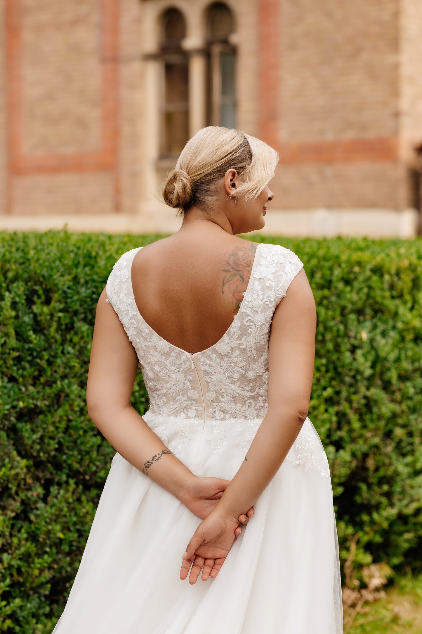 Custom-fit plus size bridal gown with lace cap sleeves and flattering neckline