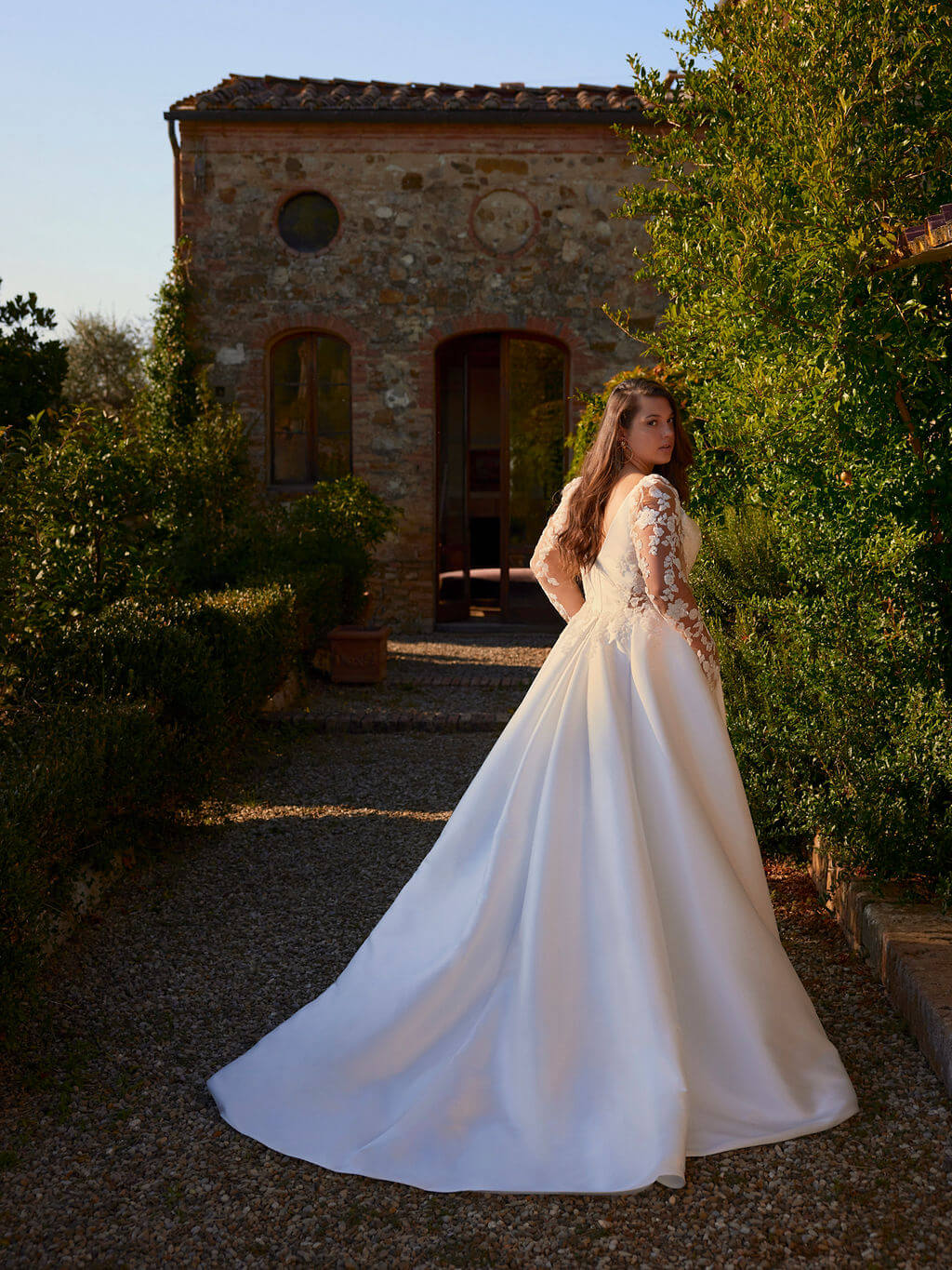 Satin wedding dress for full figure bride with deep V-neck and button back