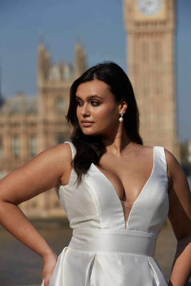 Side angle of elegant plus size wedding gown with high slit and flattering fit