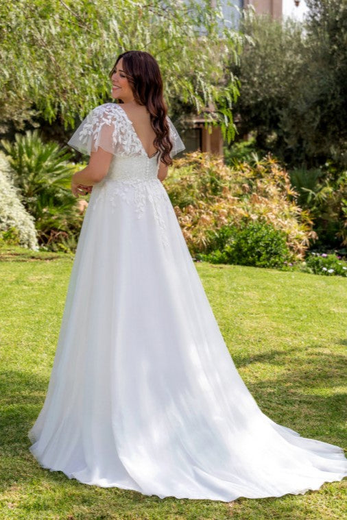 Flowy plus size A-line dress with long train and intricate embroidery for romantic weddings