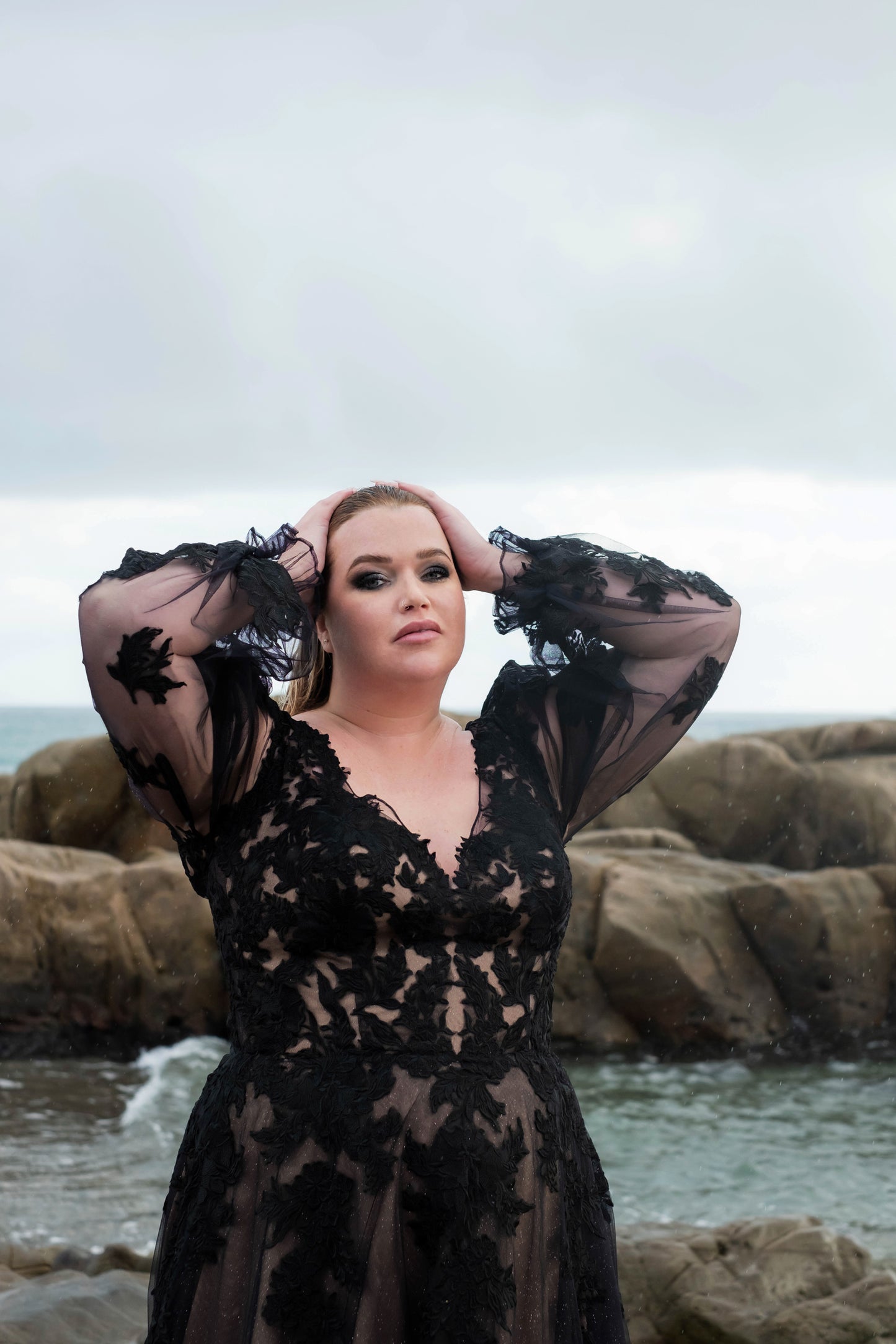 Gothic-style black wedding dress for curvy brides with deep V neckline and puff sleeves