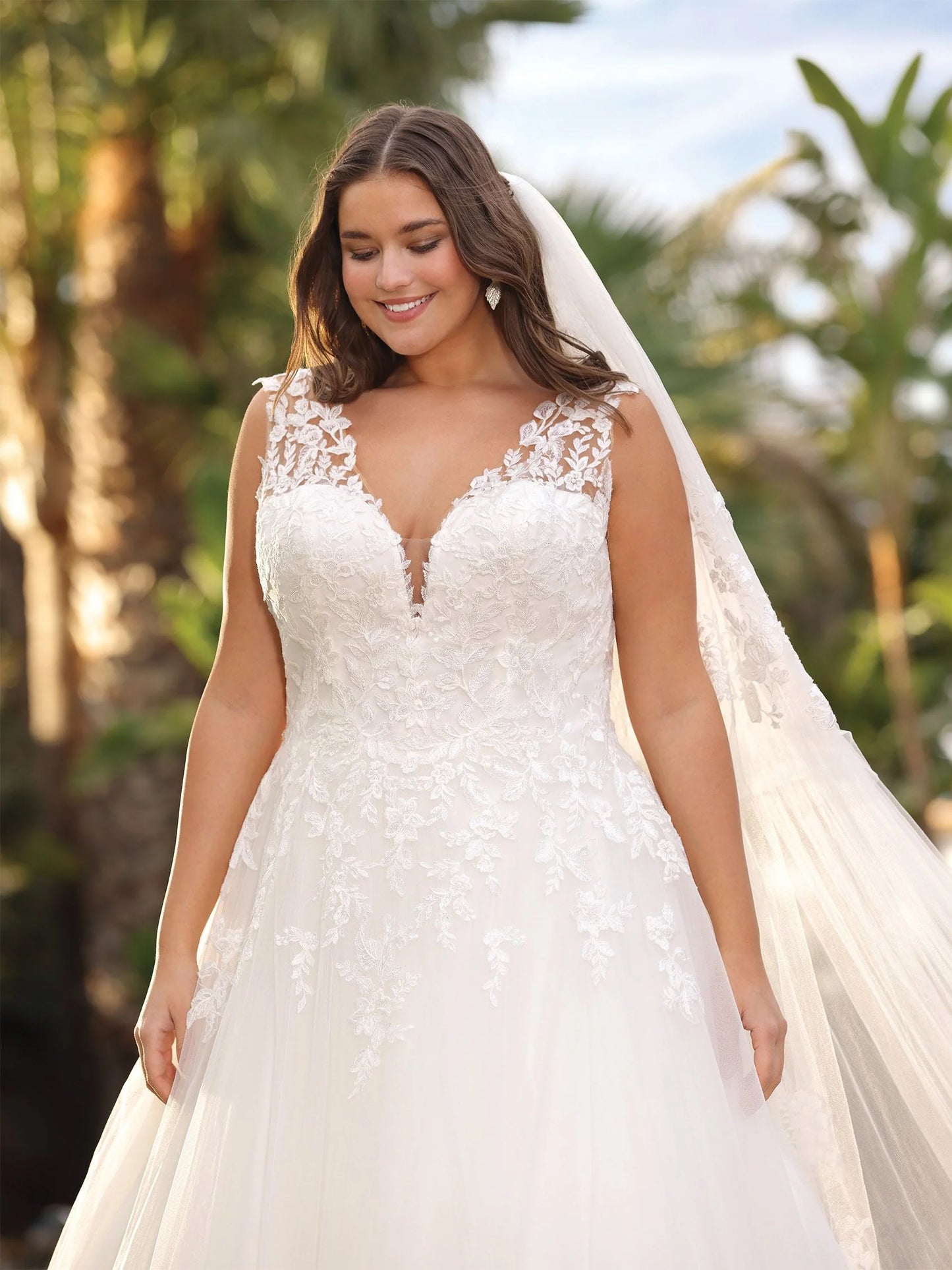 Back view of plus size wedding gown with lace-up corset and chapel train