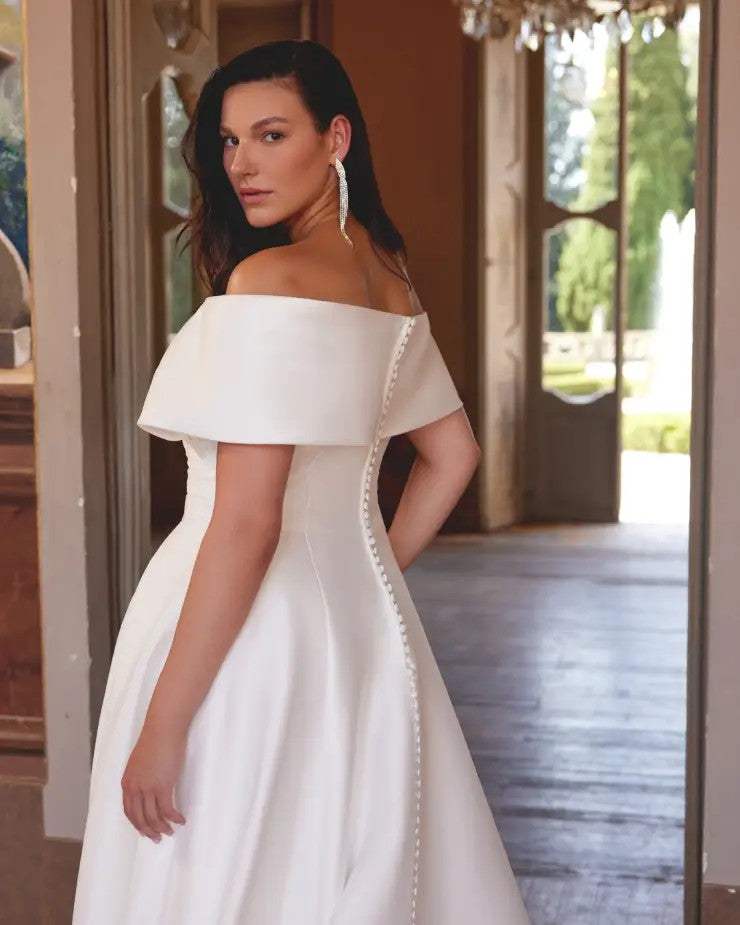 Modern curvy bride in structured satin gown with flattering silhouette