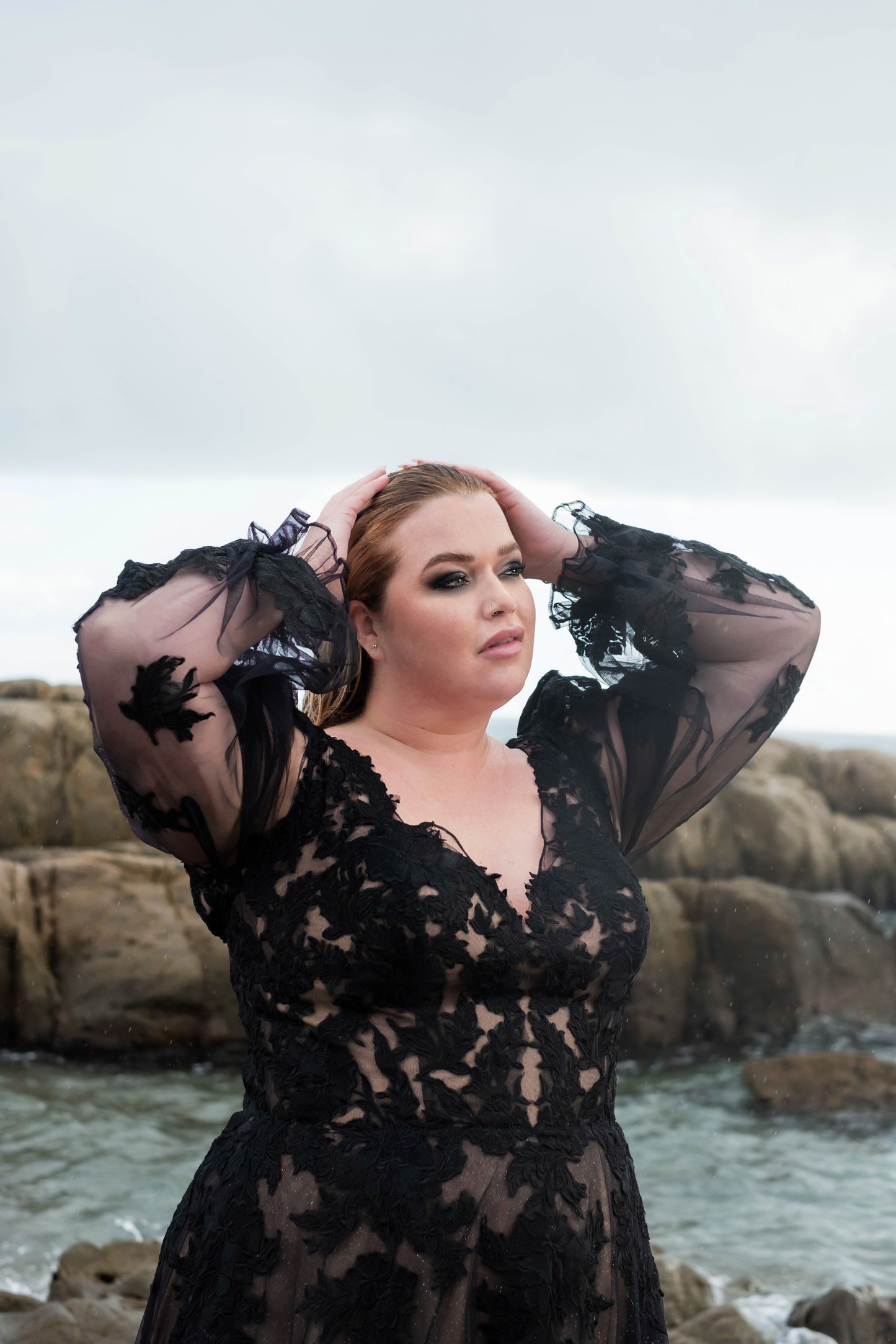 Off-shoulder black wedding dress with sheer long sleeves, flattering fit for curvy brides
