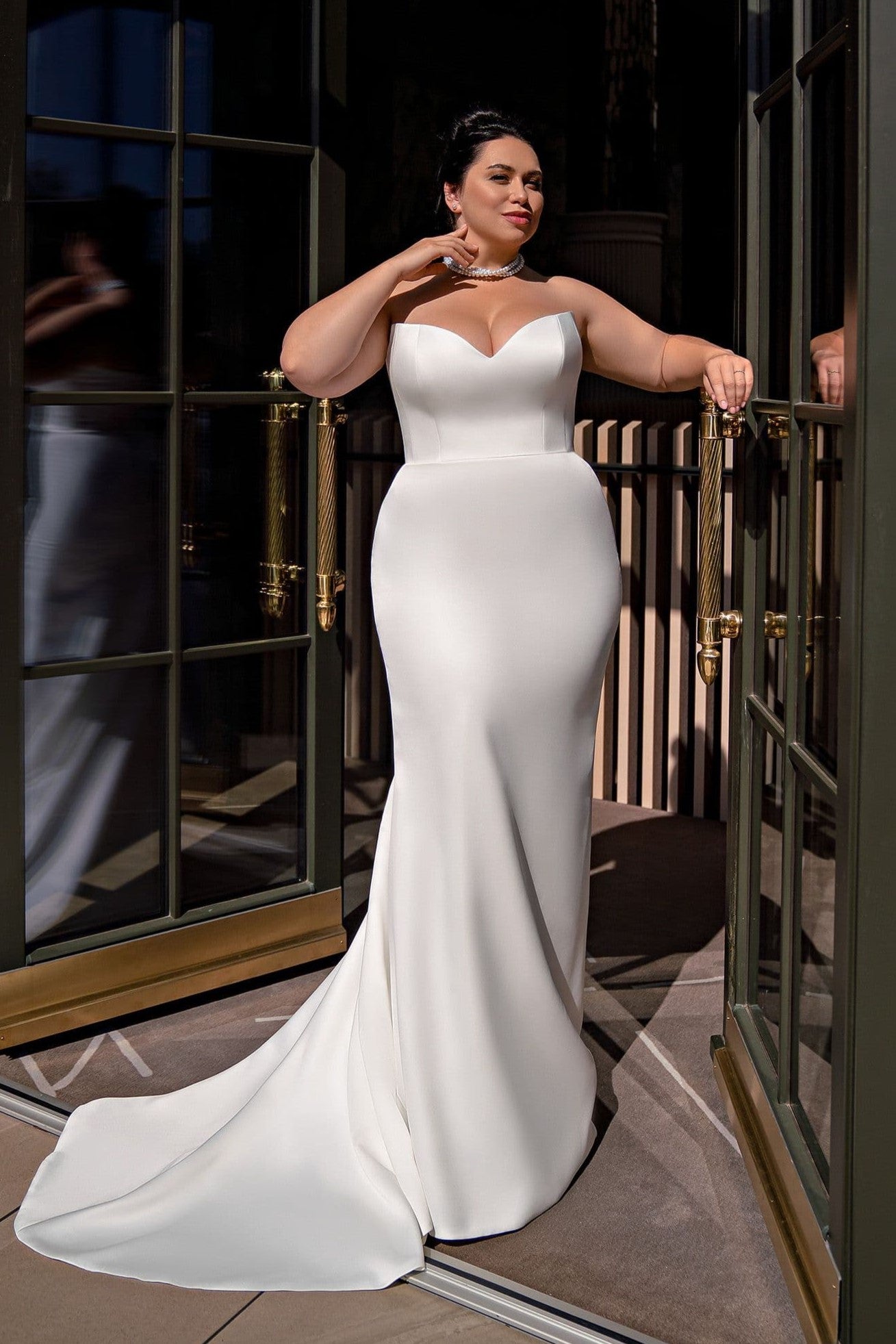 Off shoulder satin bridal gown for curvy bride with a classic silhouette