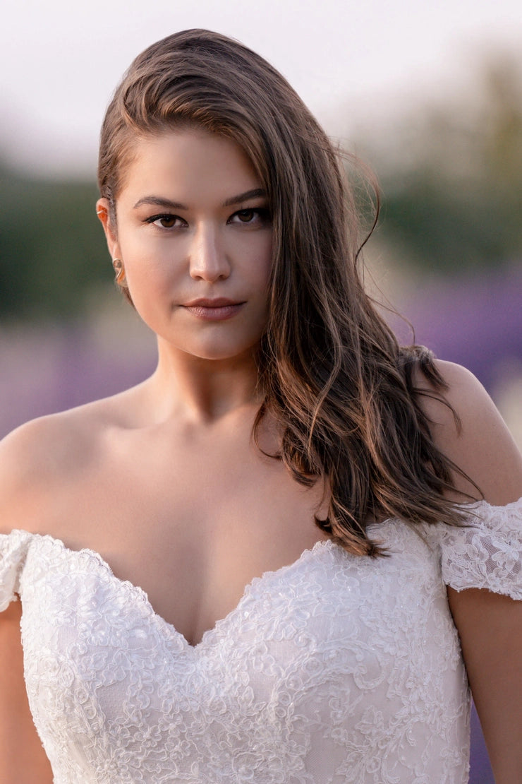 Romantic bridal gown with button-back closure, off-shoulder sleeves, and floral lace details for curvy bride