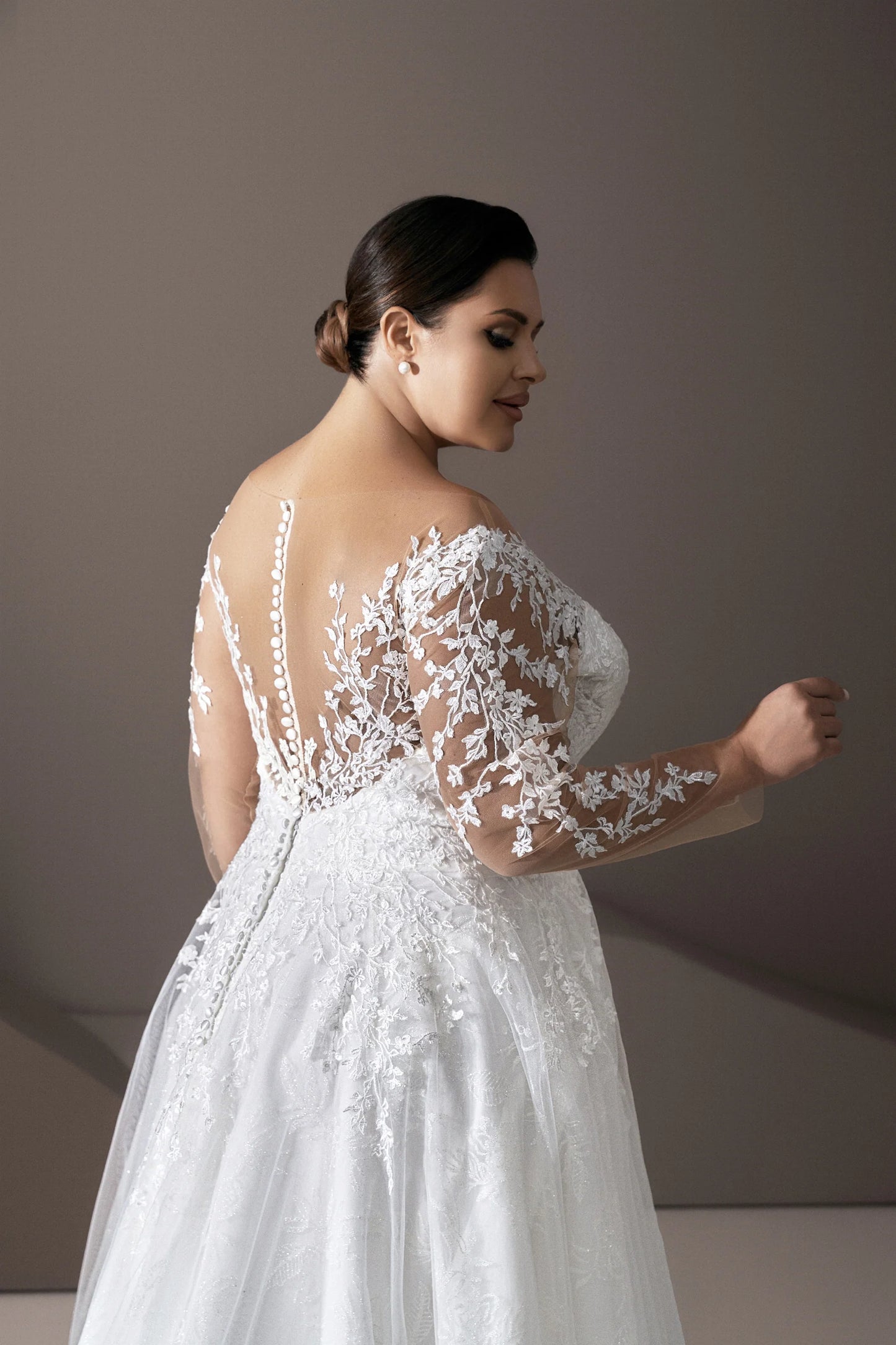 Detail of long illusion lace sleeves on plus size bridal gown