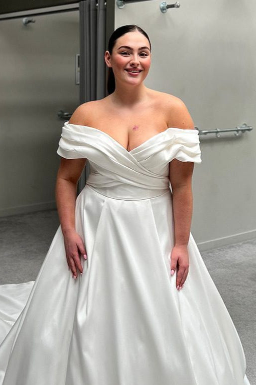Full-length plus size wedding gown with elegant train and back button detail