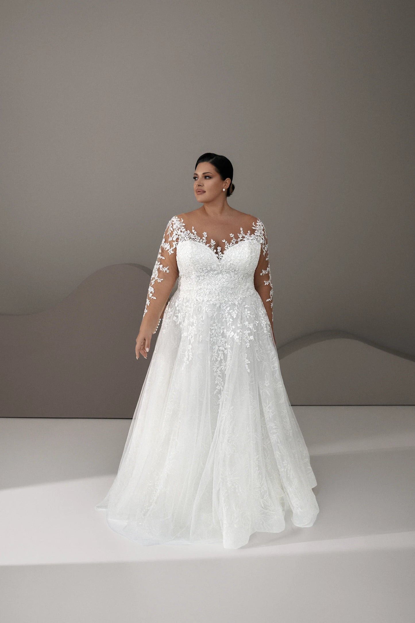 Front view of plus size lace wedding dress with illusion neckline