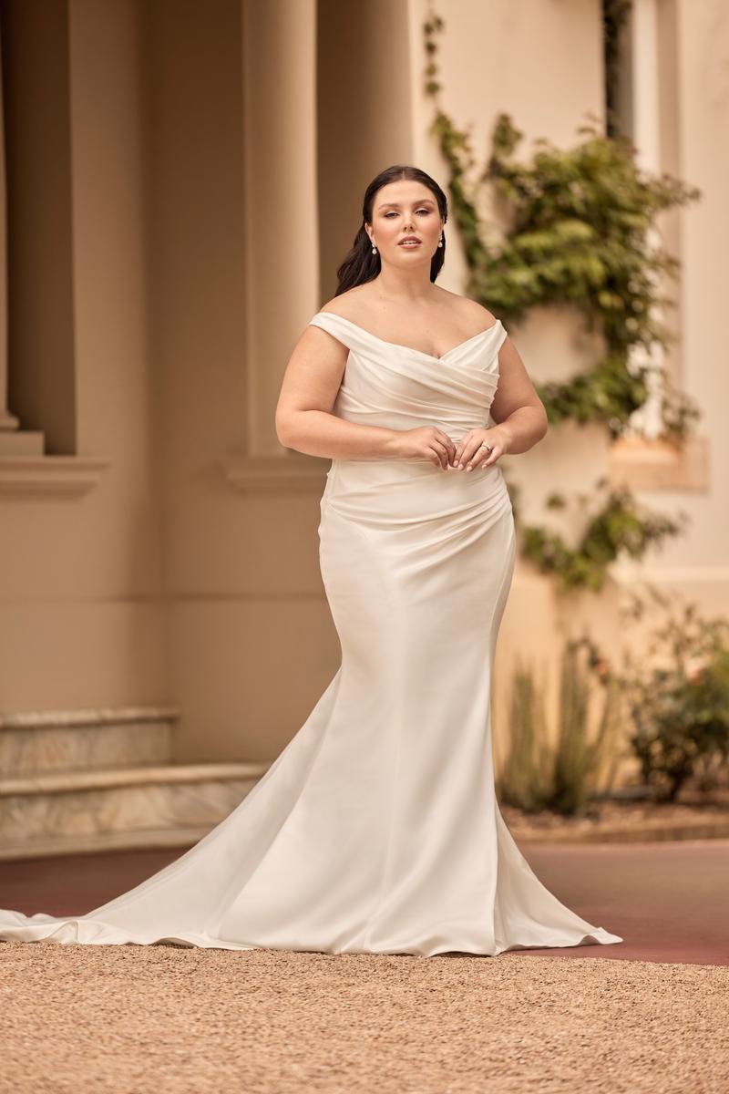 Off-shoulder satin mermaid wedding dress for plus-size bride with curve-hugging fit and elegant neckline