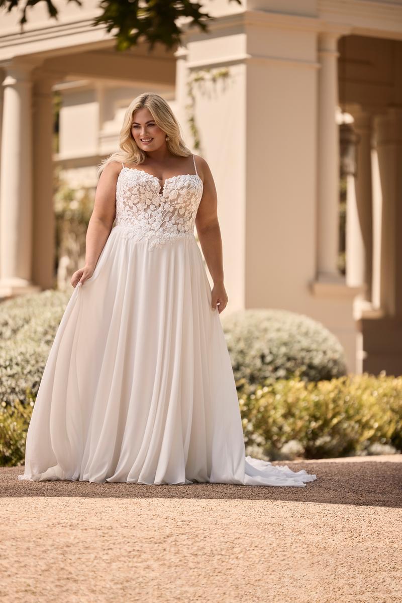 plus size wedding dress with chiffon skirt and lace bodice in natural sunlight