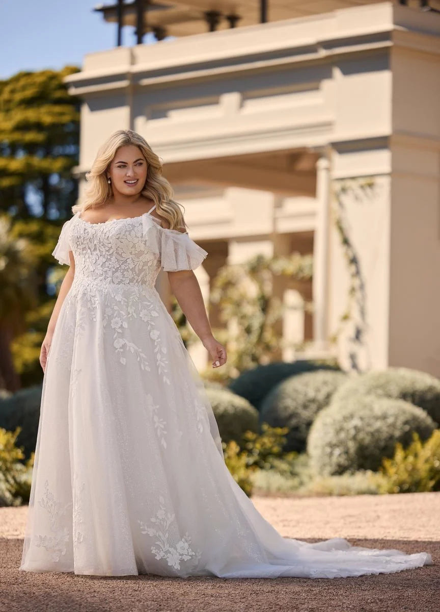 Plus size wedding dress with shiny tulle and lace in outdoor garden