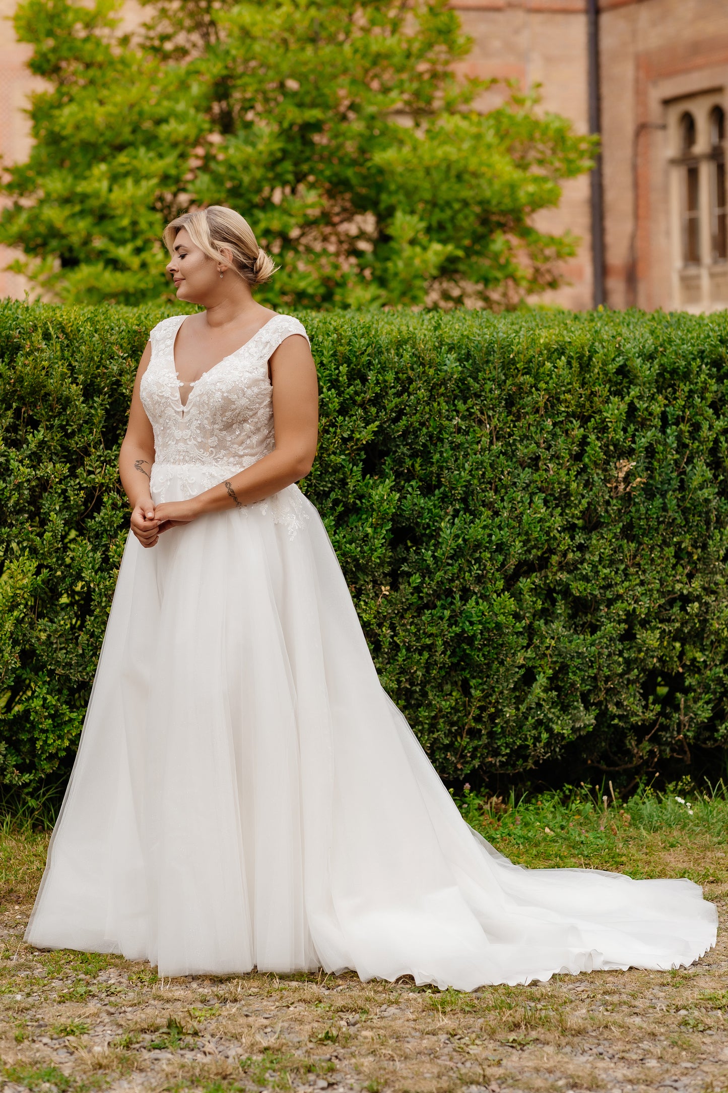 Plus size wedding dress featuring structured lace bodice and soft tulle skirt