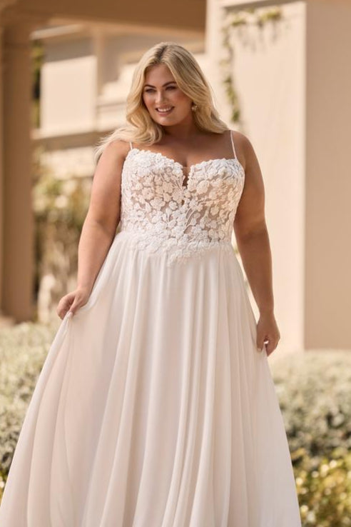 romantic a-line bridal gown designed for curvy bride with floral applique