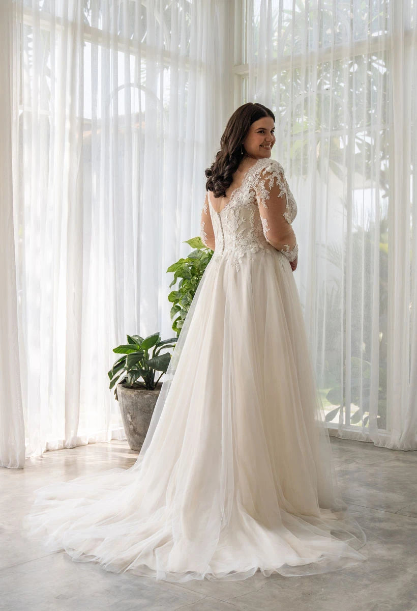Romantic A-line wedding dress for plus-size women featuring floral lace details and gentle train