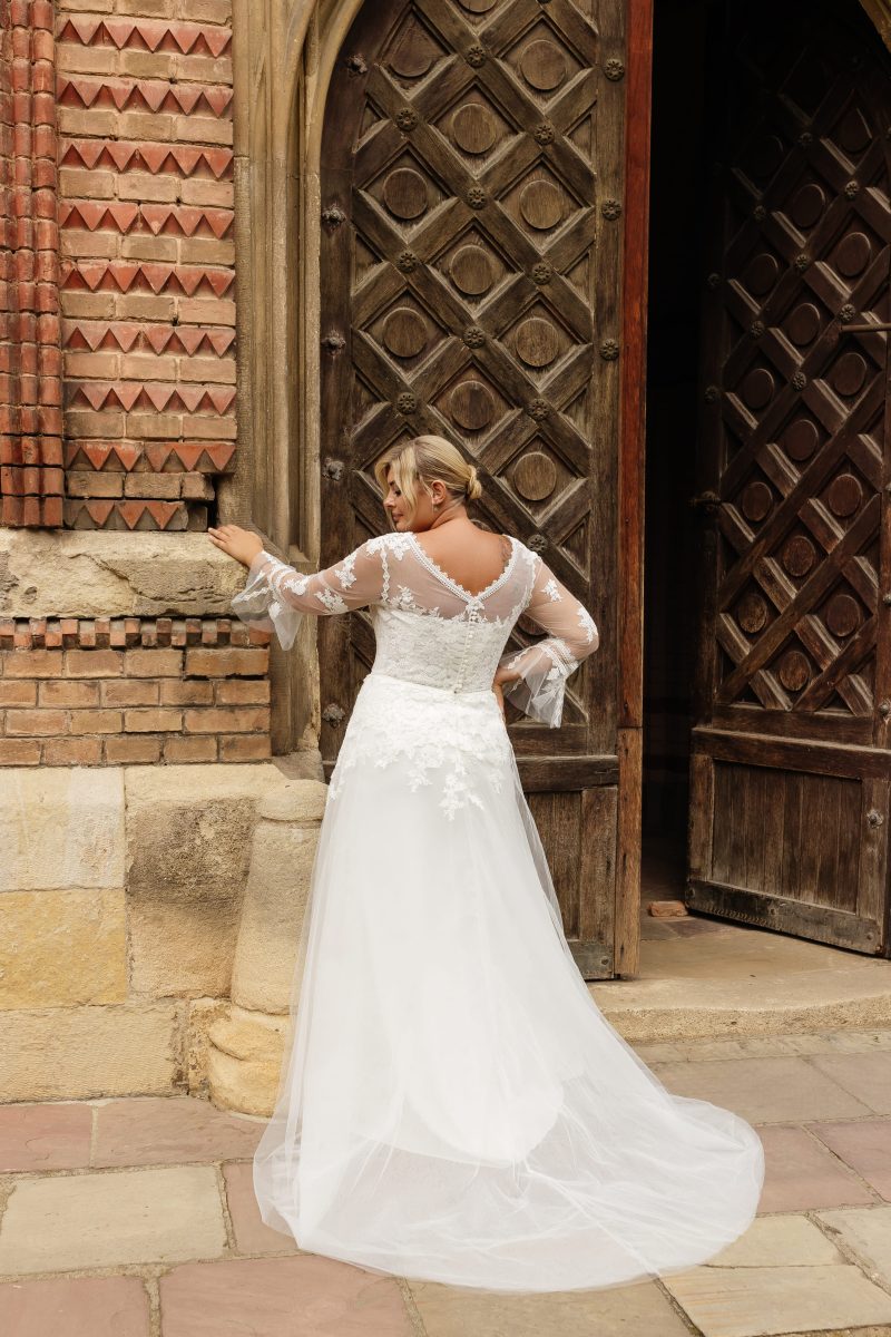 Romantic lace applique wedding gown with sheer sleeves and flattering A-line cut for full-figured brides
