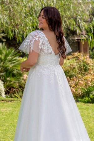 Romantic 2025 wedding dress for plus size brides with flattering A-line shape and soft details