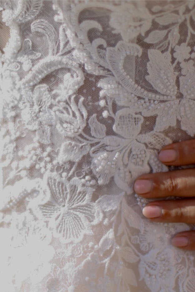 Romantic plus-size wedding dress with corset back, lace embroidery, and flattering full-skirt design