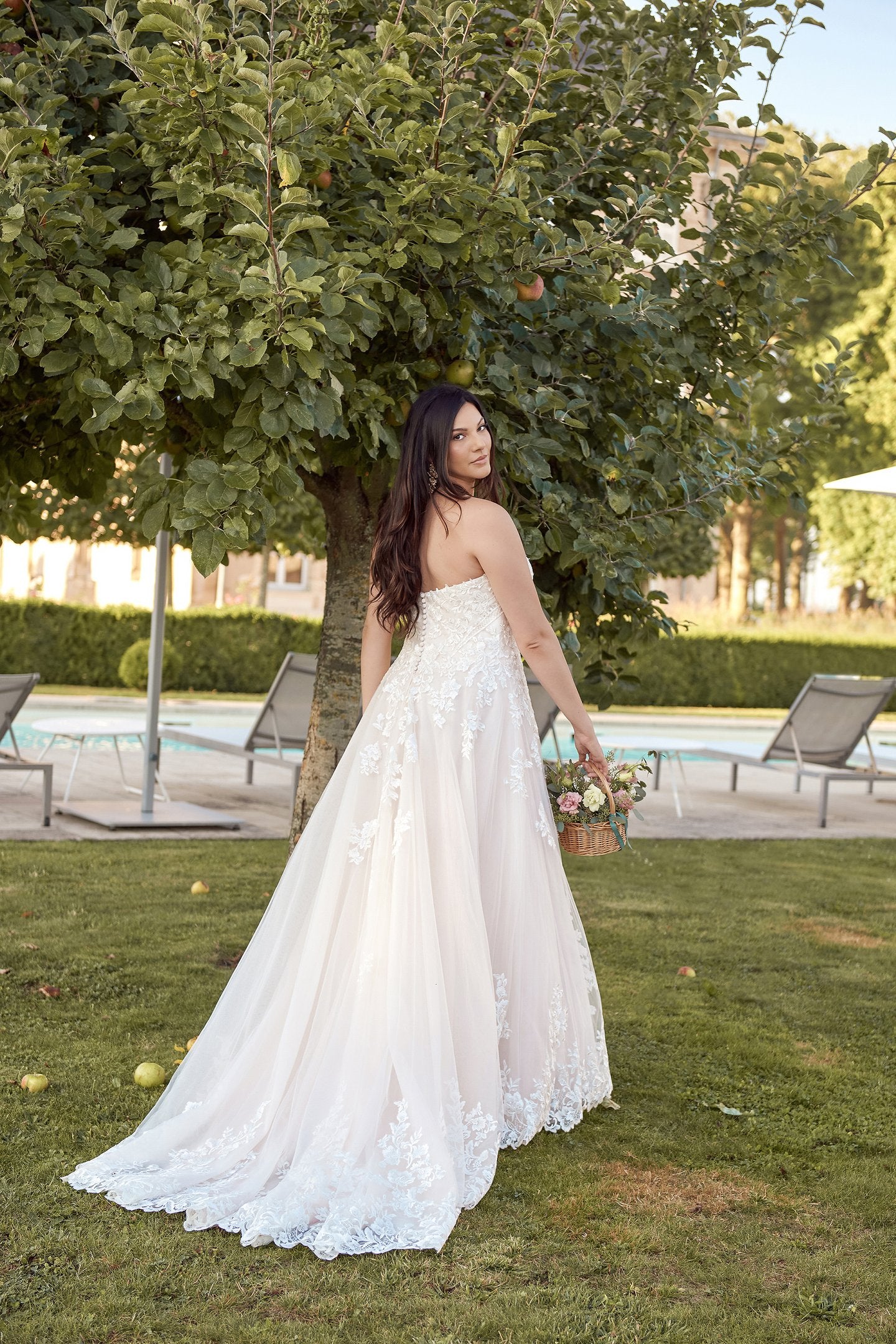 Custom plus-size wedding gown with soft lace, strapless design, and dreamy tulle skirt