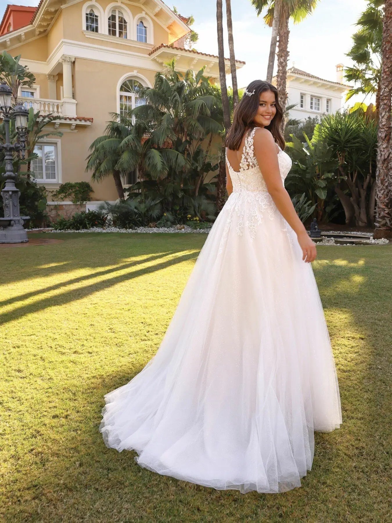 Romantic tulle wedding gown with floral appliqué for plus size brides