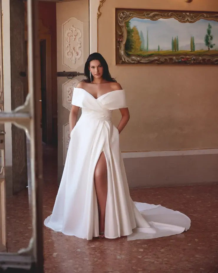 Satin bridal gown for curvy brides featuring a bold side slit and supportive bodice