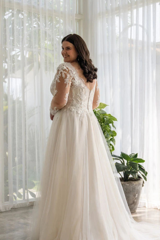 Lightweight tulle A-line gown for plus-size bride with flowing movement and flattering waist