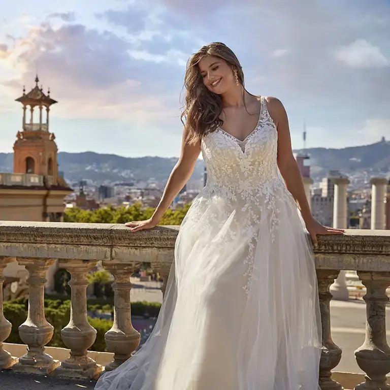 Curvy bridal gown with sleeveless bodice and romantic floral lace