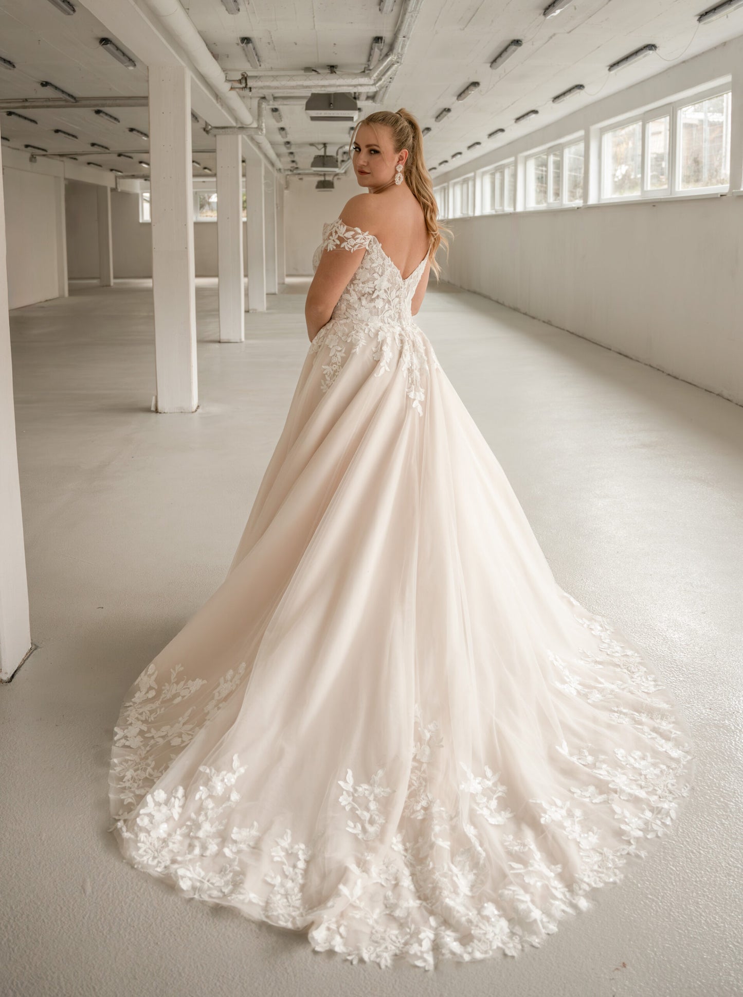 Plus size wedding dress with V-neckline and off-shoulder straps