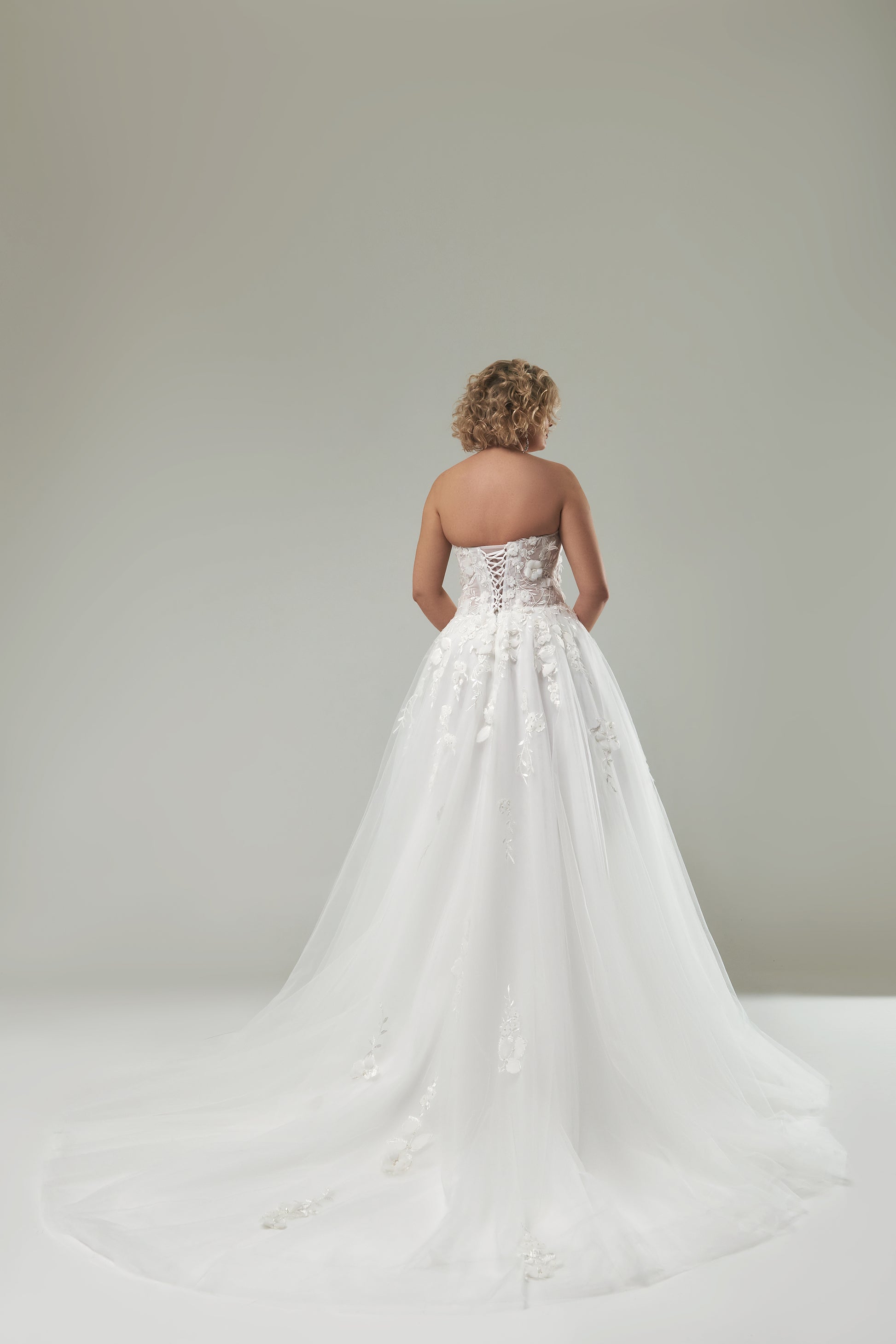 Bridal gown with handmade 3D floral lace appliqués for full-figured women

