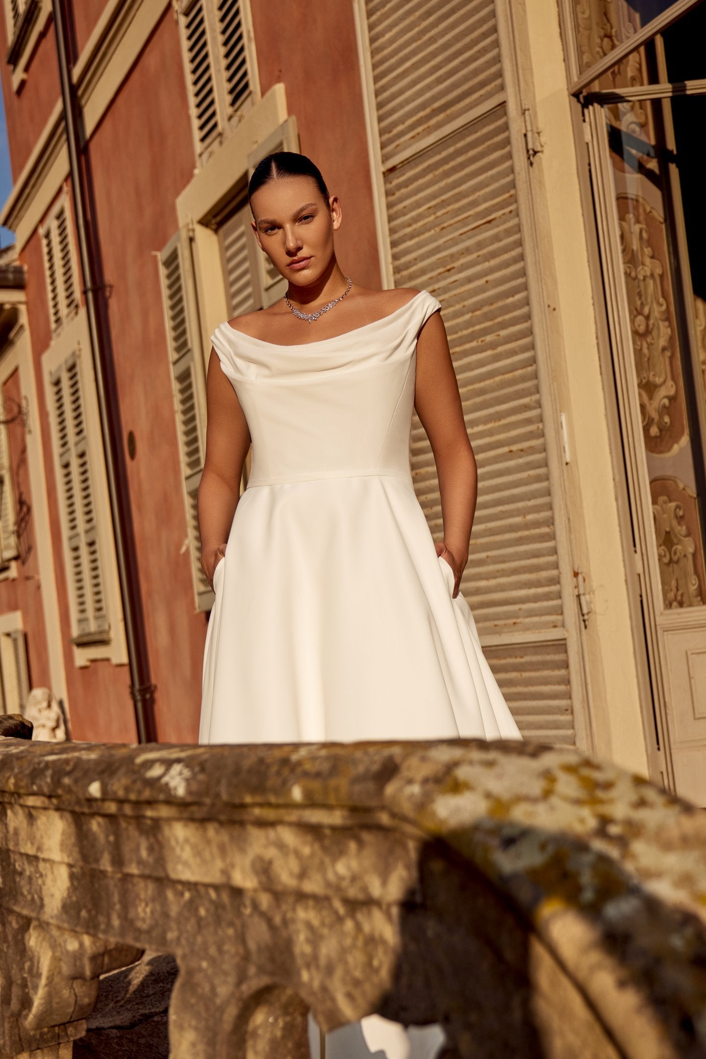 A-line satin wedding gown for curvy brides featuring hidden side pockets