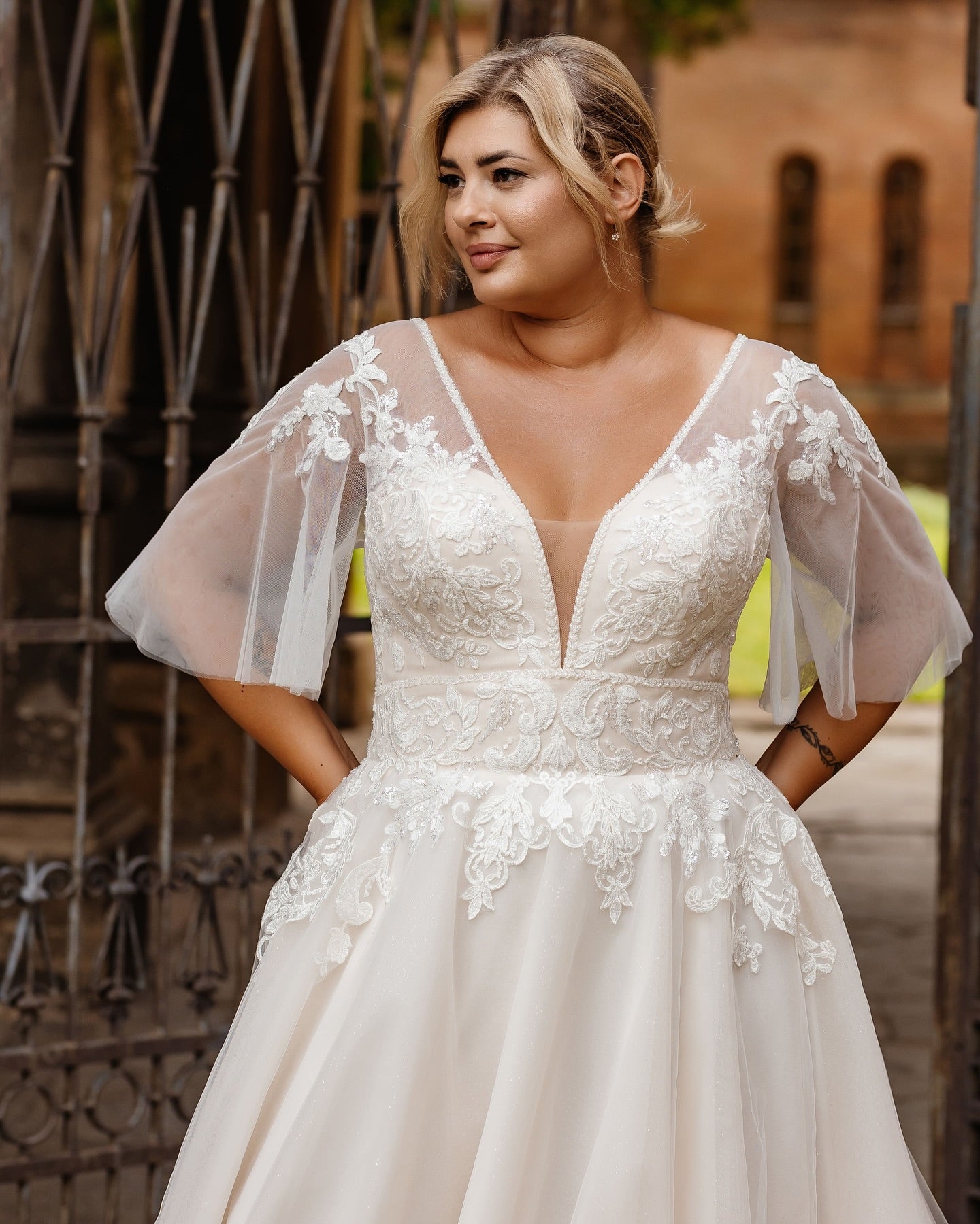 Backless plus size wedding gown with illusion mesh and cascading lace details