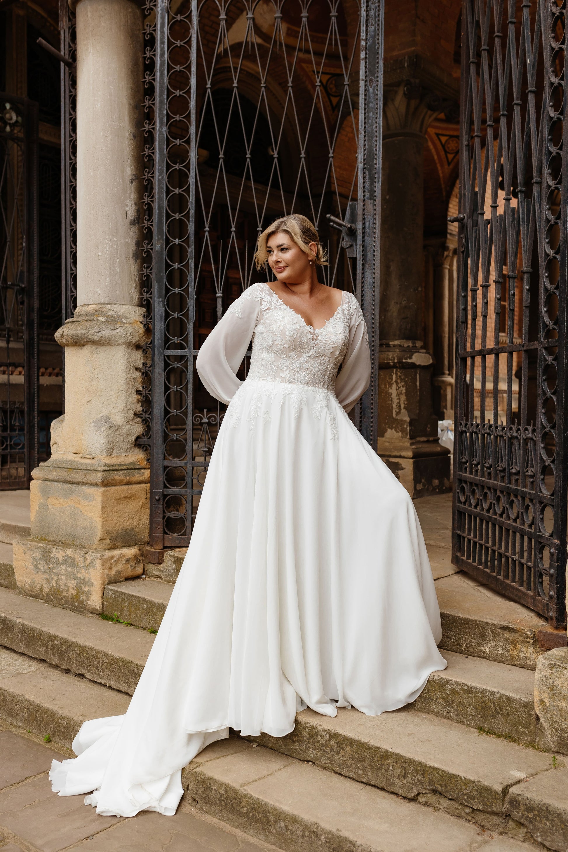 Back view of boho wedding gown with sheer lace and sweep train for curvy bride