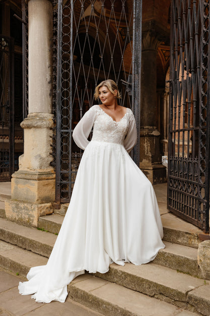 Back view of boho wedding gown with sheer lace and sweep train for curvy bride
