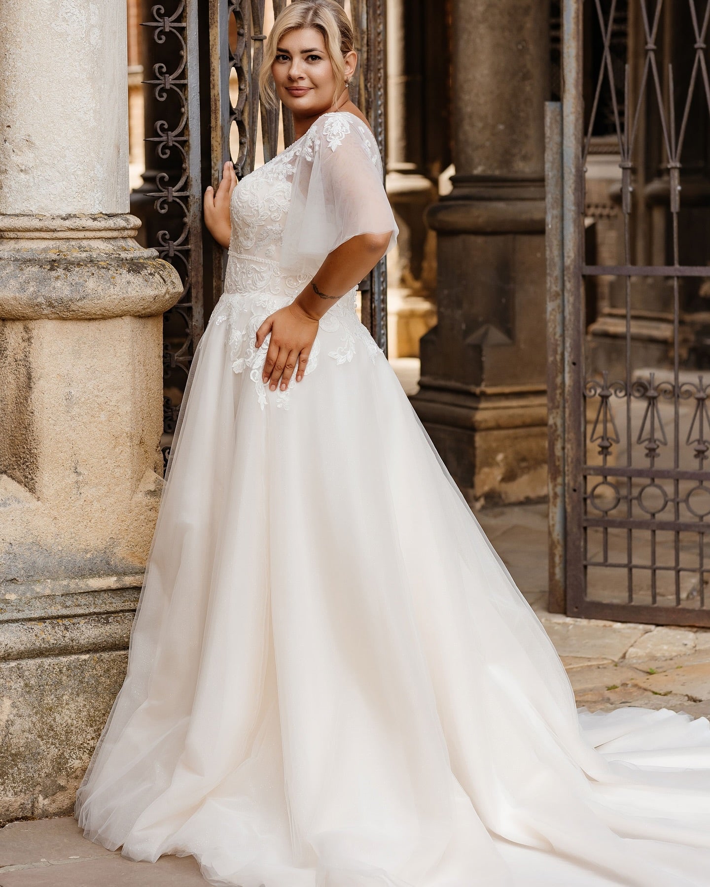Elegant plus size bridal gown featuring A-line silhouette and detailed lace bodice