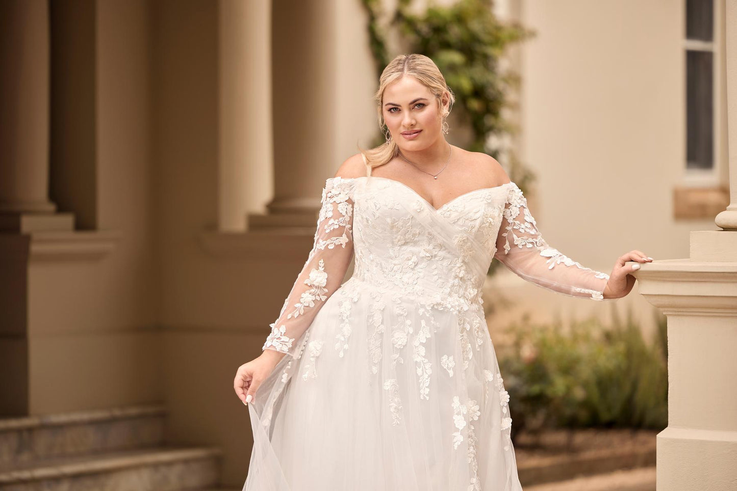 Elegant side-slit bridal gown with romantic lace, long sleeves, and lightweight A-line silhouette

