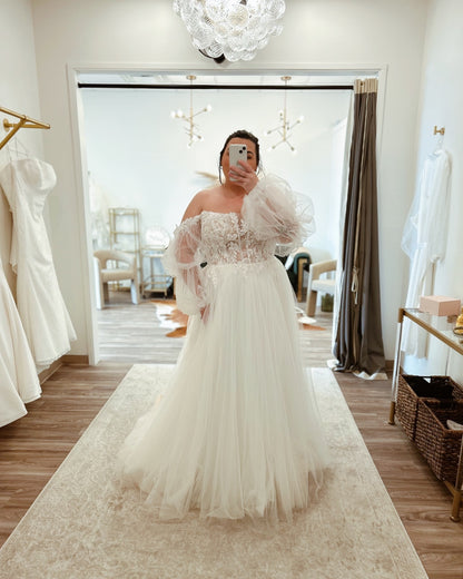 Plus size bridal gown with puff sleeves and floral lace