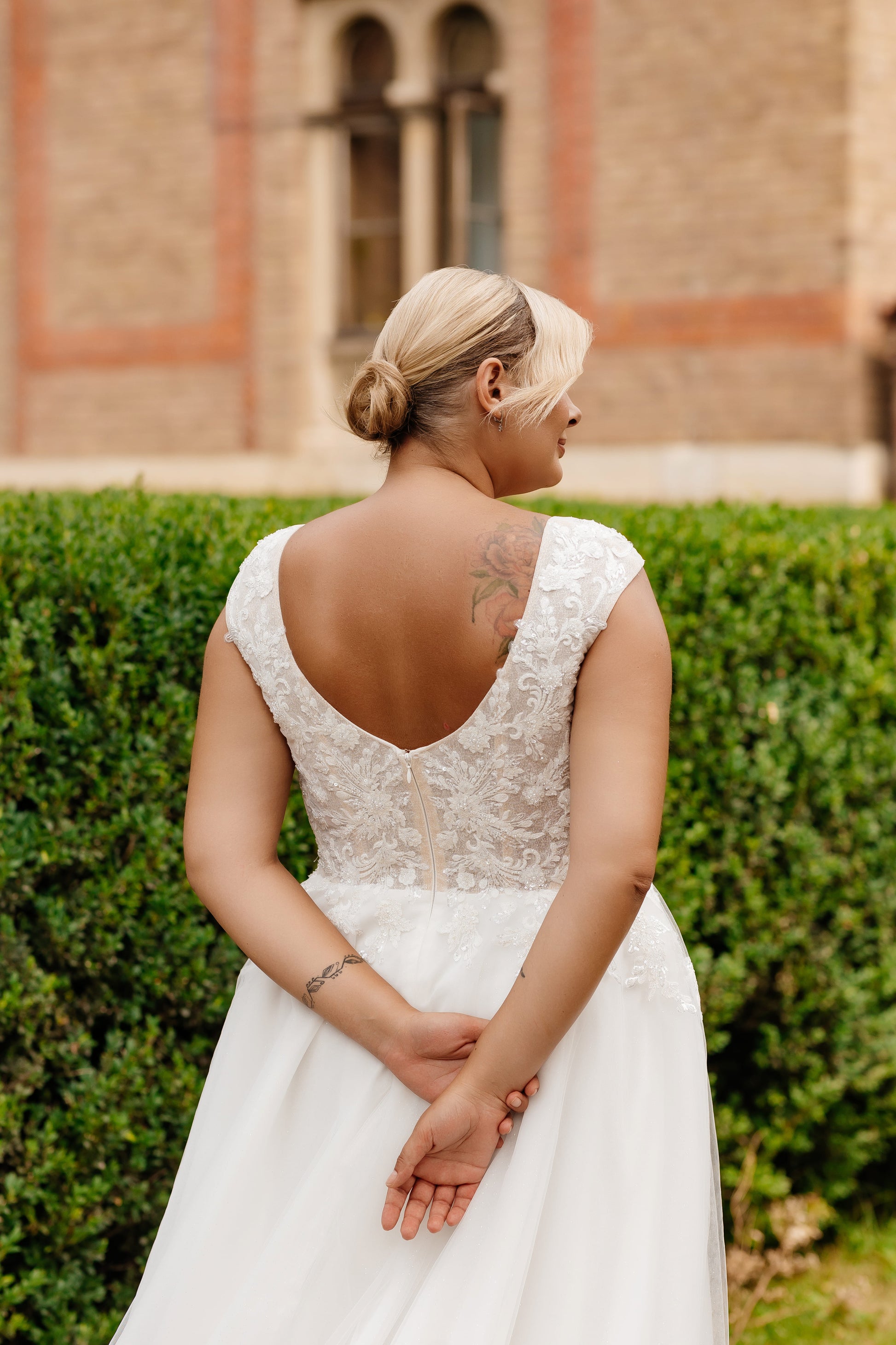 Custom-fit plus size bridal gown with lace cap sleeves and flattering neckline

