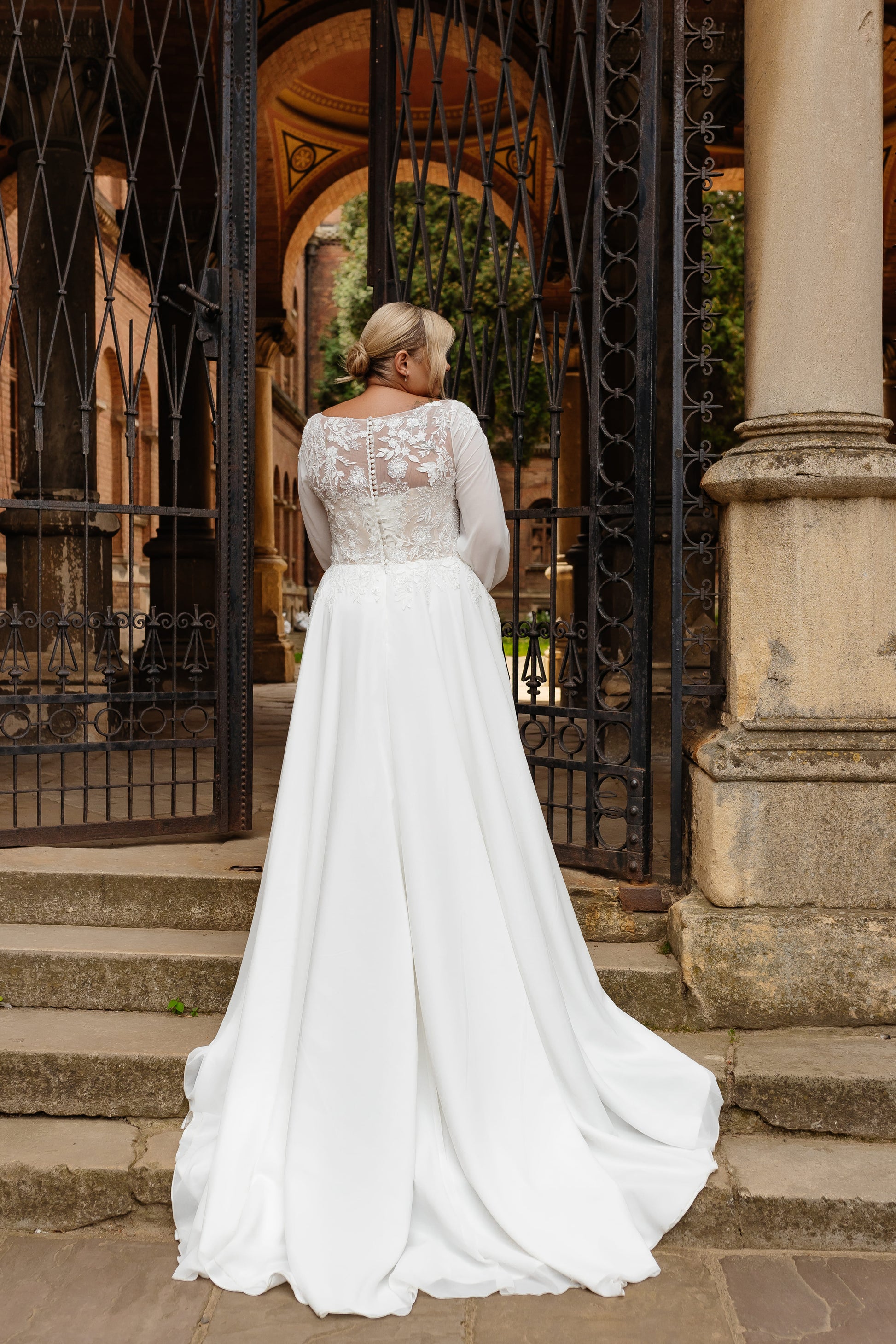 Illusion lace back wedding gown with button closure for full figure bride