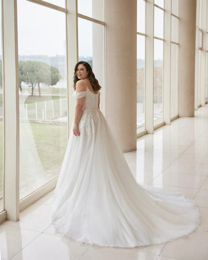 Elegant plus size wedding dress made from lightweight tulle for romantic look
