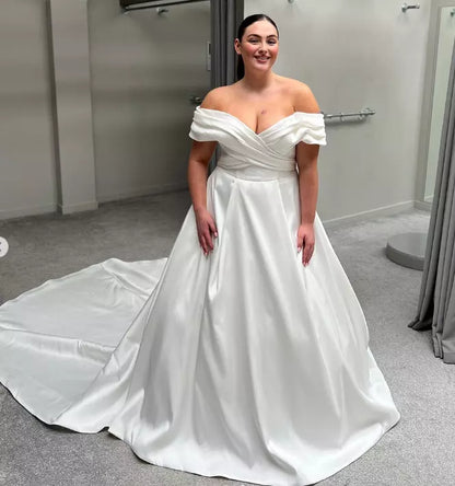 Flattering off shoulder wedding gown perfect for curvy women on their big day