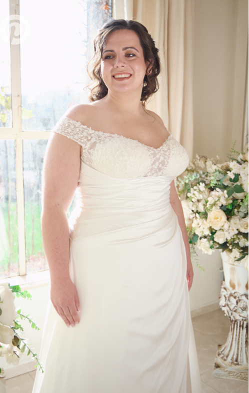 Figure-flattering plus size bridal gown with ruched pleated bodice