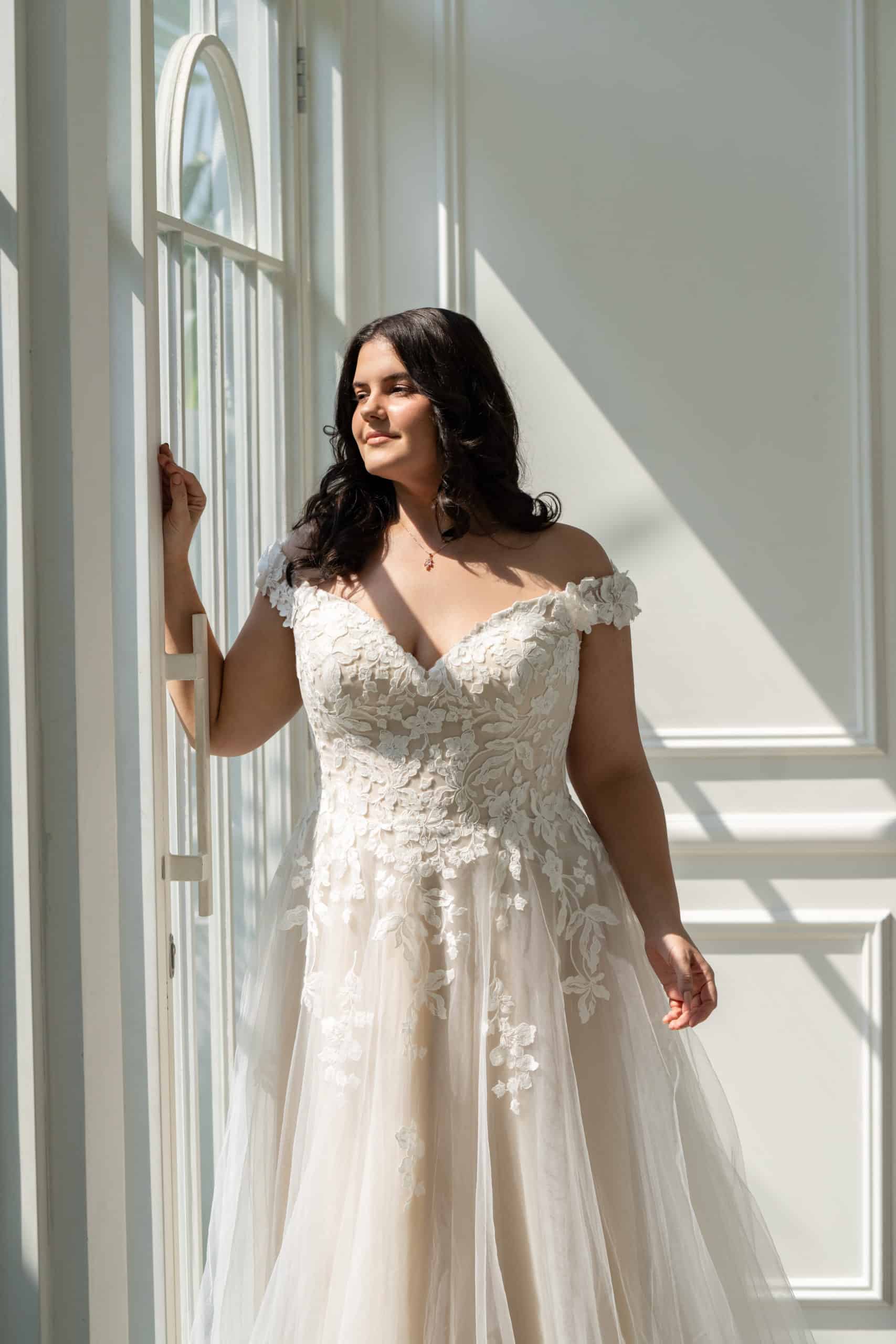 Illusion back bridal gown with floral lace appliqué for curvy brides

