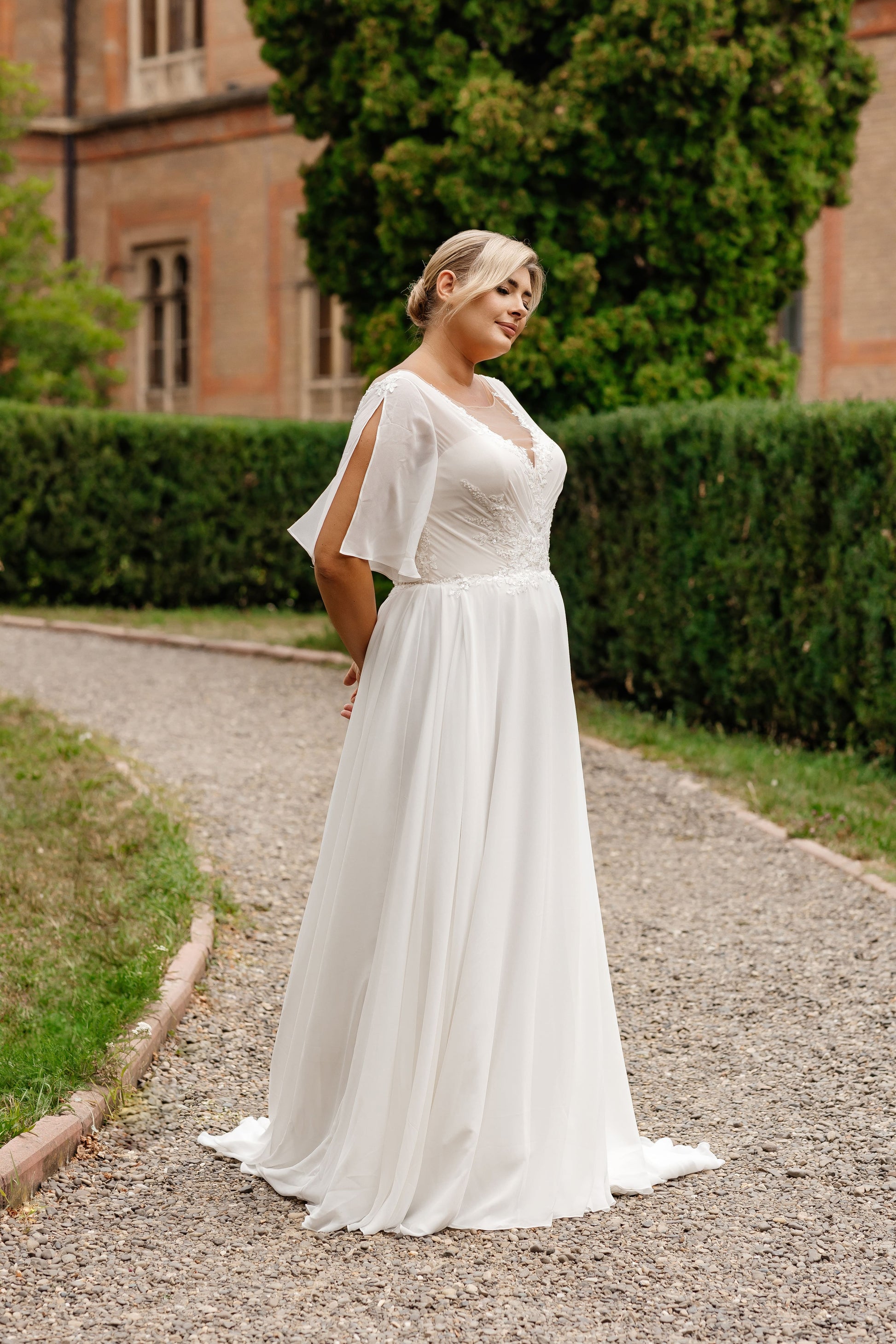 Inclusive bridal dress for full-figured women with flutter sleeves and elegant a-line cut
