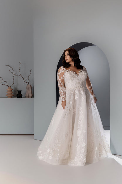 Curvy bridal gown with long illusion sleeves and floral lace appliqués