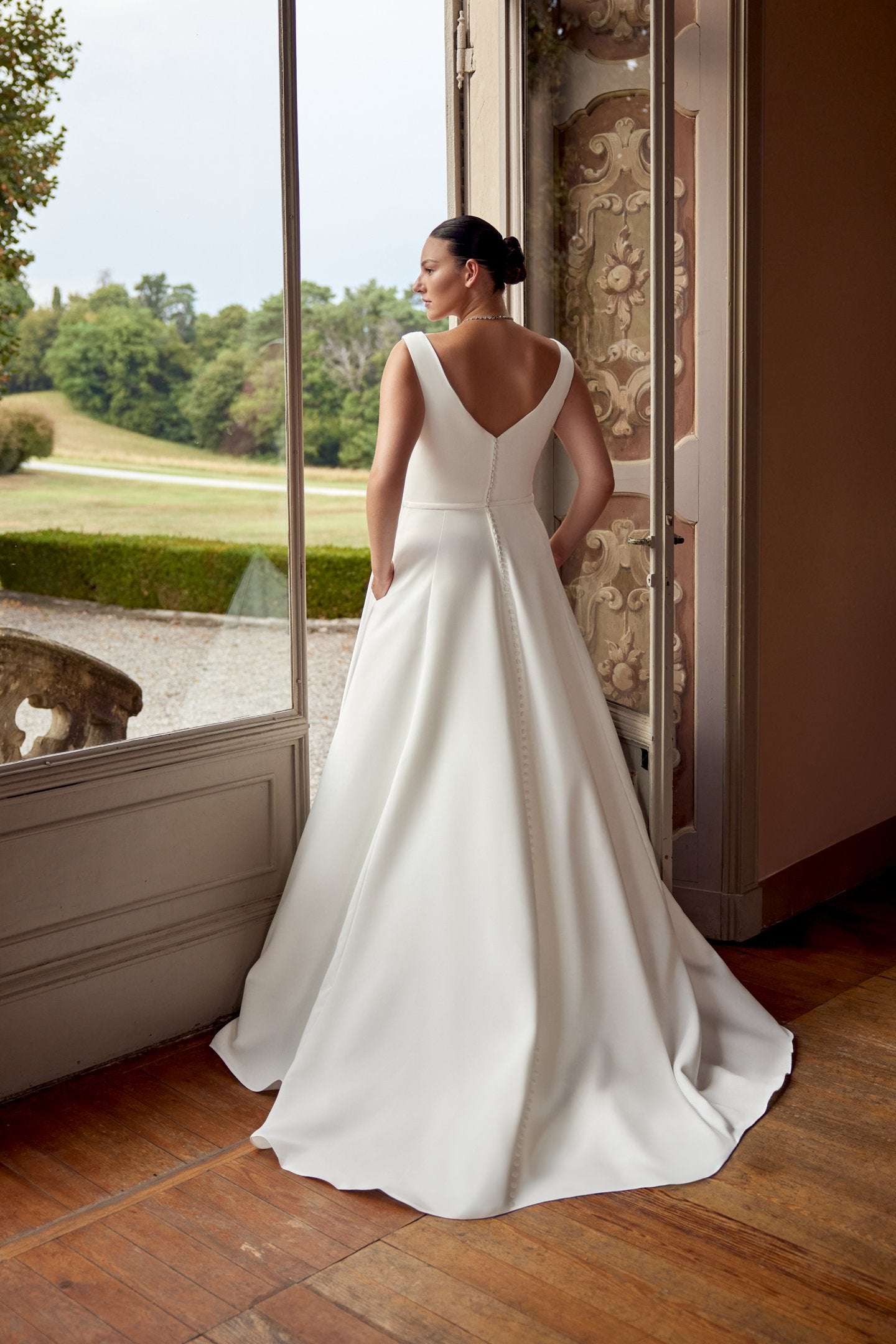Modern wedding dress with satin texture and supportive wide straps