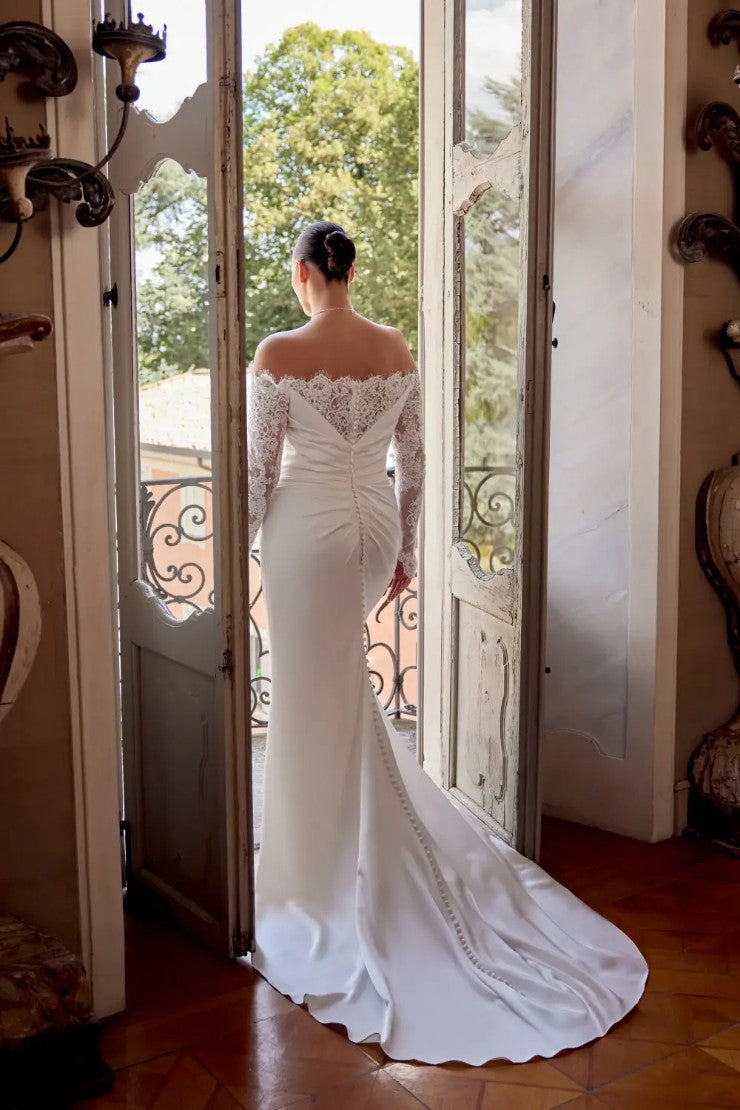 Modern satin wedding dress with draped bodice and body-hugging shape
